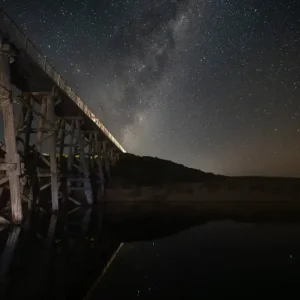 astro photography featuring a trestly bridge and milky way