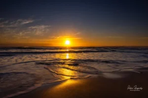Golden sunrise reflecting over the waves at Phillip Island beach