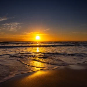 Golden sunrise reflecting over the waves at Phillip Island beach